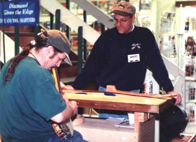 A woodworking show visitor tries one of my banjos.