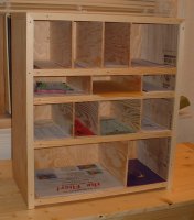 A plywood organizer for holding various forms and labels.